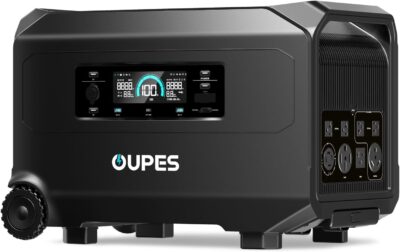 OUPES Guardian 6000 Portable Power Station showing the front panel with AC outlets, LCD screen, and rugged wheels on a wooden floor.