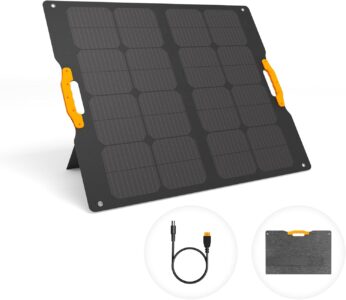 UDPOWER 120W foldable portable solar panel set up on a grassy field with kickstands facing the sun