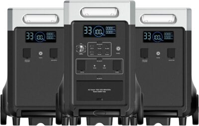 The AFERIY P310 portable power station main unit stacked with two extra expansion battery packs, illuminating a modern home garage setting during a simulated power outage.