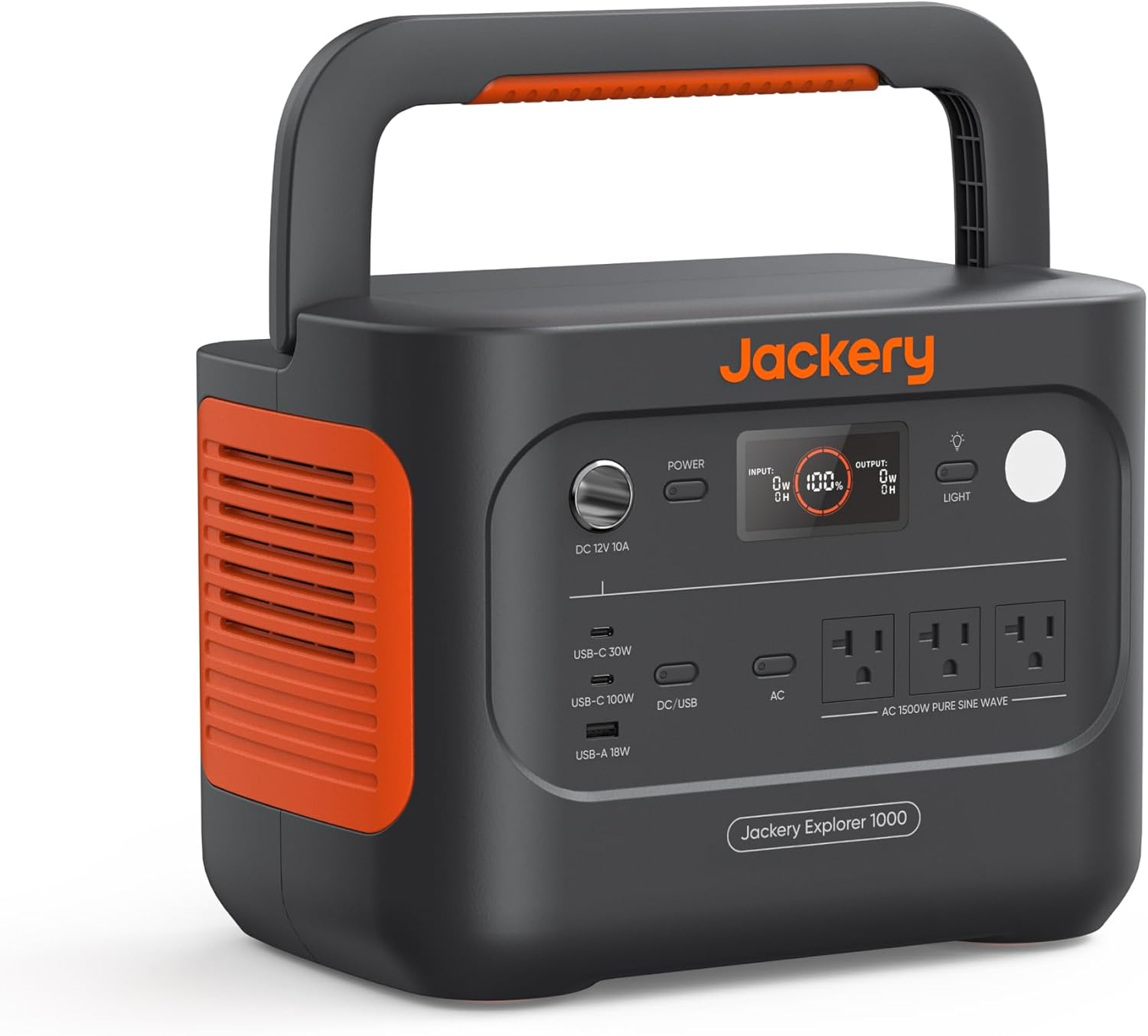 The Jackery Explorer 1000 v2 portable power station sitting on a camping table next to a laptop and a coffee maker in a forest setting.