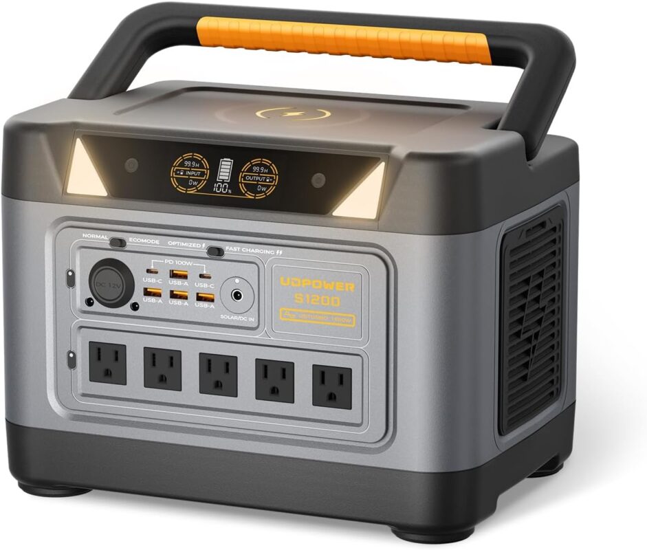 UDPOWER S1200 portable power station with LCD screen showing 100% battery, connected to a camping fridge in an outdoor setting