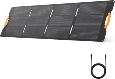 UDPOWER 210W foldable solar panel standing on its adjustable kickstands on green grass under a clear blue sky