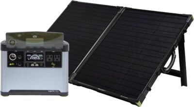 Goal Zero Yeti 700 portable power station and Boulder 100 solar panel set up at a forest campsite during a rainy day to show IPX4 water resistance.