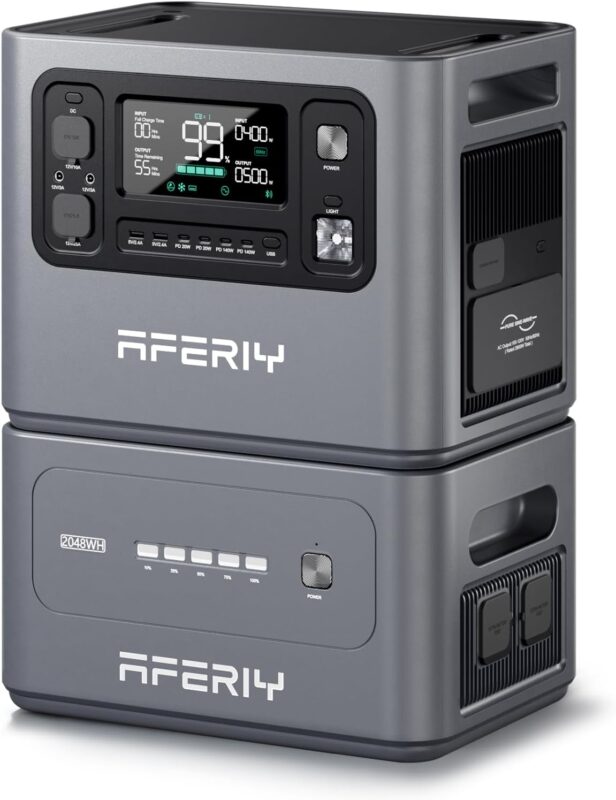 The AFERIY P210 portable power station main unit stacked with its extra expansion battery in a modern living room, connected to a laptop and a large TV.
