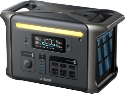 Anker SOLIX F1500 portable power station sitting on a wooden bench in a forest setting with its front LED display lit up