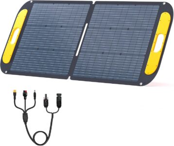 VTOMAN VS110 foldable 110W solar panel set up on a green field with adjustable kickstands under bright sunlight.