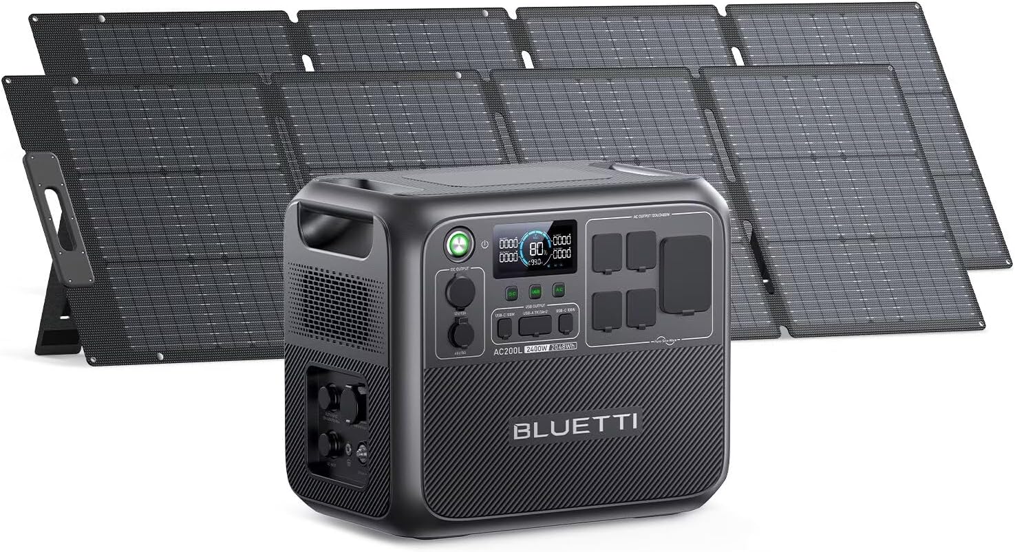 The BLUETTI AC200L solar generator with two 200W solar panels deployed on a sunny campsite next to a modern camper van.