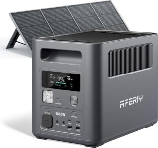 AFERIY 1024Wh Portable Power Station sitting on a forest floor connected to a folded 200W solar panel charging under the sun.