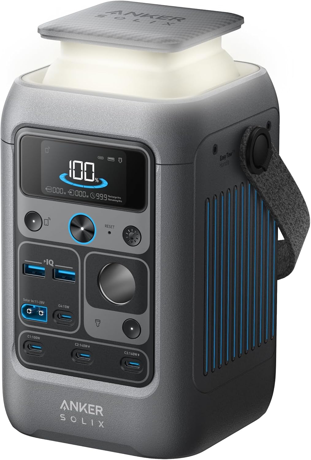 Anker SOLIX C300 DC portable power station with its built-in light turned on sitting on a camping table next to a laptop and smartphone