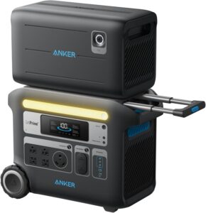 Anker SOLIX F2000 portable power station with the 760 expansion battery stacked on top, showing the connecting cable and AC ports in a camping setting