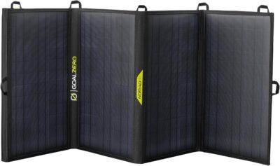 Goal Zero Nomad 50 foldable monocrystalline solar panel unfolded on a wooden camping table in the sun