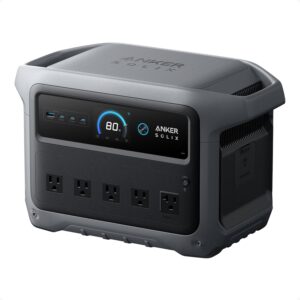 Anker SOLIX C1000 Gen 2 portable power station with LED display showing 100% battery charge on a camping table