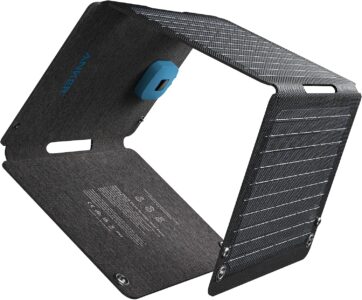 Anker Solix PS30 30W foldable solar panel unfolded on a rock showing its dual USB ports and rugged fabric exterior